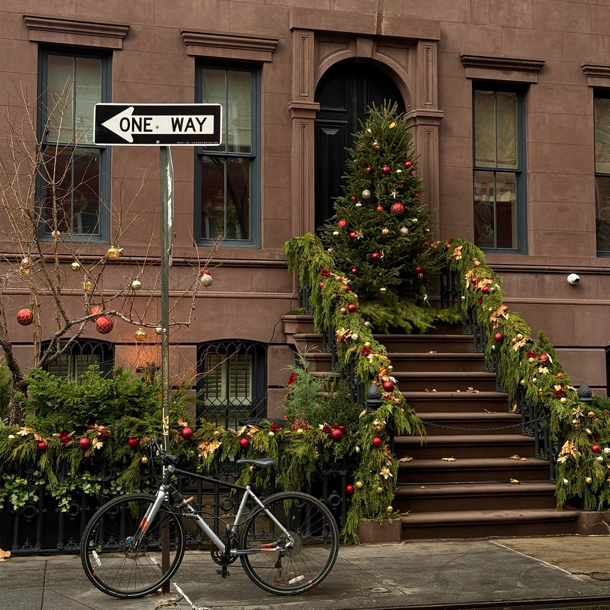 Brownstone with Christmas tree and holiday decorations.