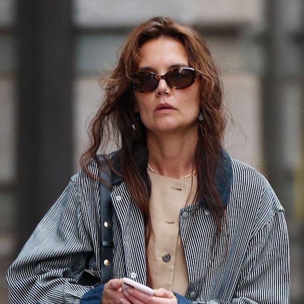 Katie Holmes wearing a navy-and-white barn jacket with camel Lafayette 148 vest and white trousers in New York City May 2024