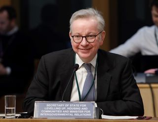 Michael Gove sitting at a talk as the secretary of Levelling-Up