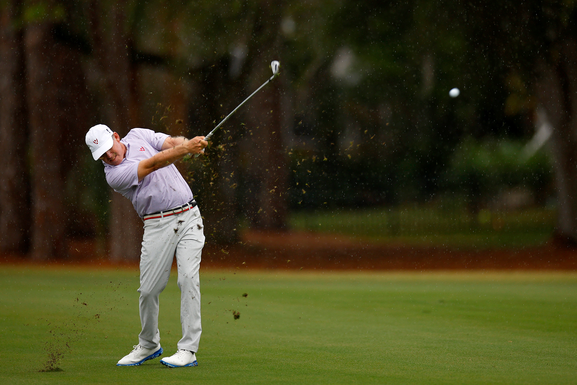 Justin Leonard past impact with an iron after hitting a shot from the fairway
