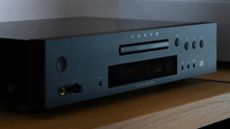Onkyo C-30 CD player on a wooden table or sideboard in a fairly dark room