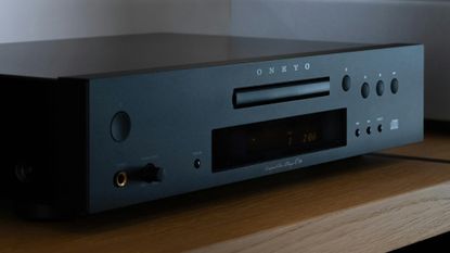 Onkyo C-30 CD player on a wooden table or sideboard in a fairly dark room