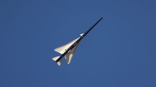 an elongated blue-and-white jet in flight