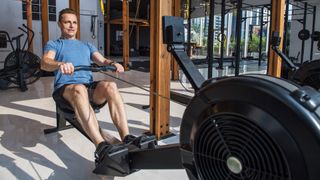 A man uses a rowing machine - Is the rowing machine a good workout?