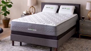 Image shows the GhostBed Luxe cooling mattress on a grey fabric bedframe