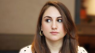 Woman looking to the side in edited portrait photo taken in a cafe
