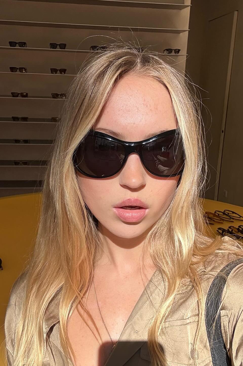 a woman wearing large black sunglasses