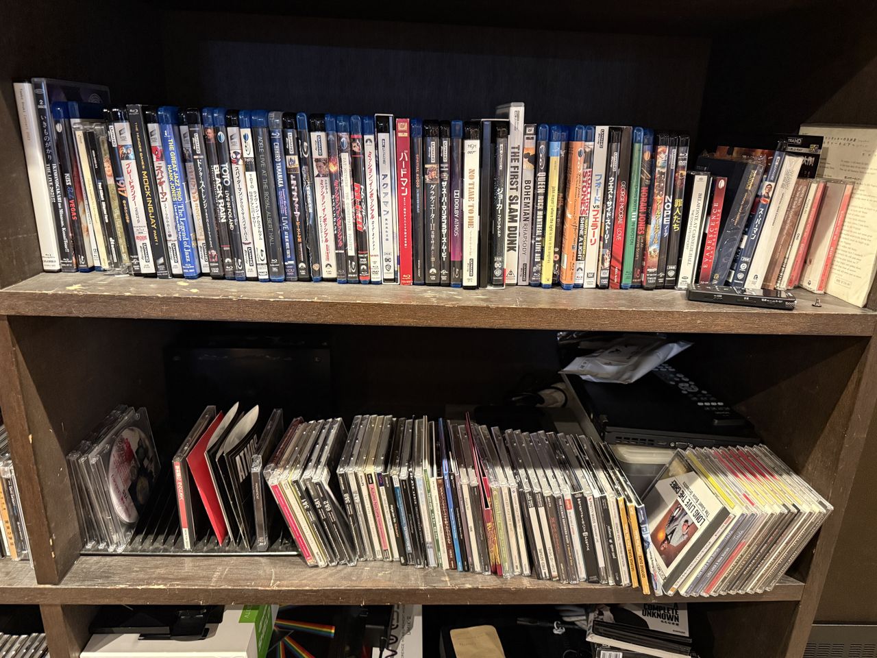 Two shelves full of Blu-ray discs (and some CDs and DVDs)