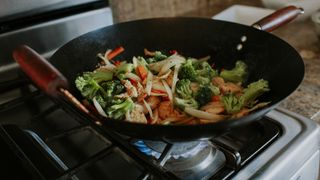 wok on a hob full of food cooking