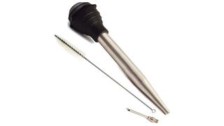 A stainless steel turkey baster with a black silicone bulb.