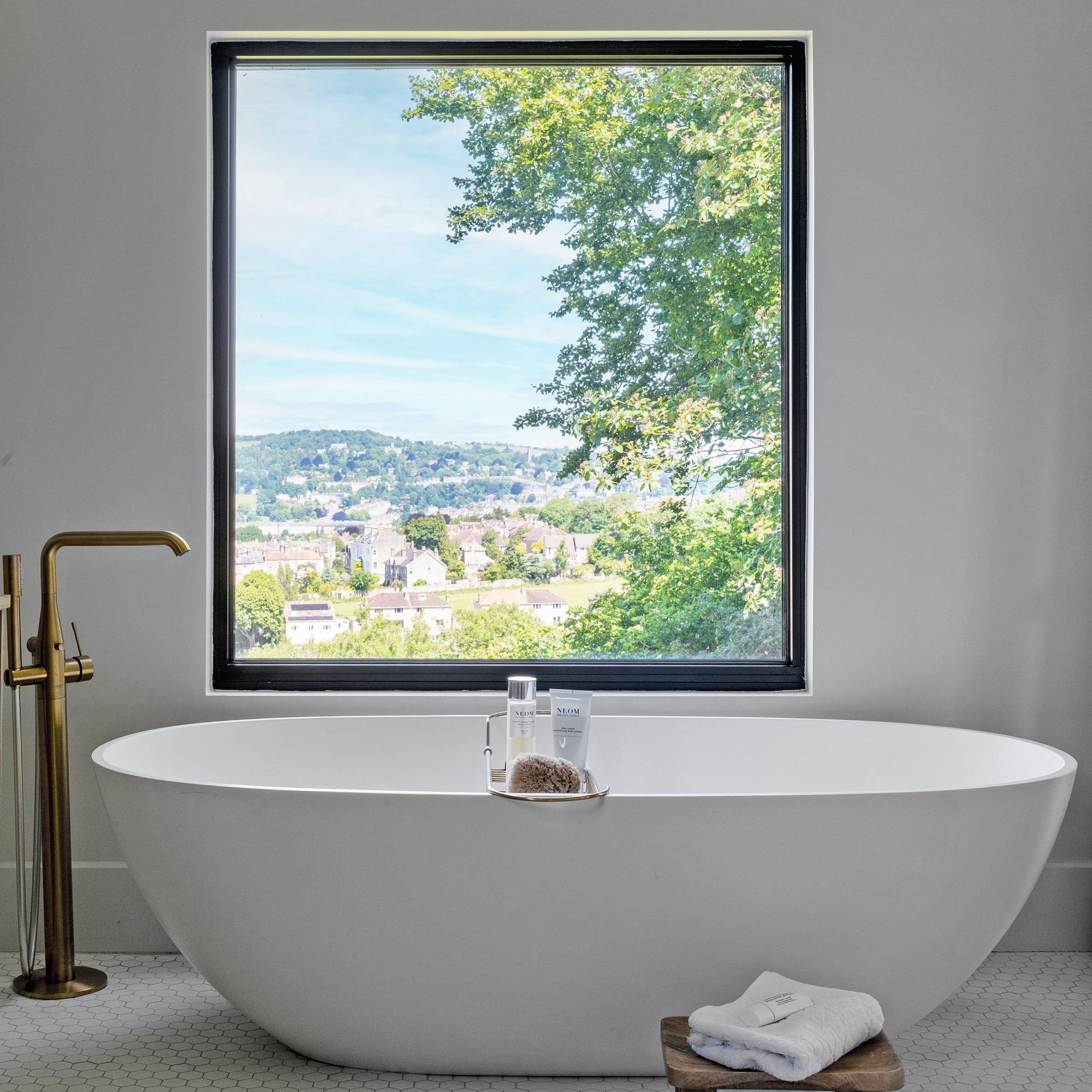 freestanding bath underneath window