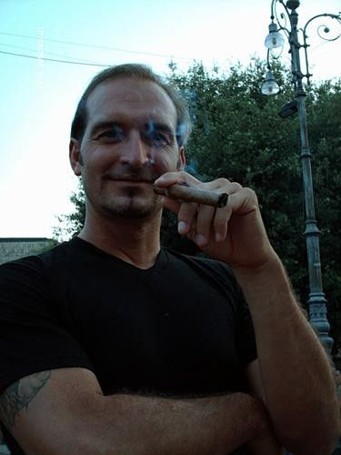 Team Whistle massage therapist Maurizio De Pasquale enjoys a Cuban cigar before the start of the World Cup final.