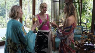 Kate, Laurie and Jaclyn in swimwear all toasting their wine glasses