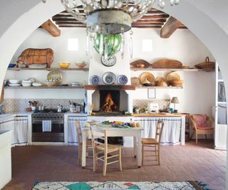 Tuscan kitchen with terracotta floor tiles and open shelving