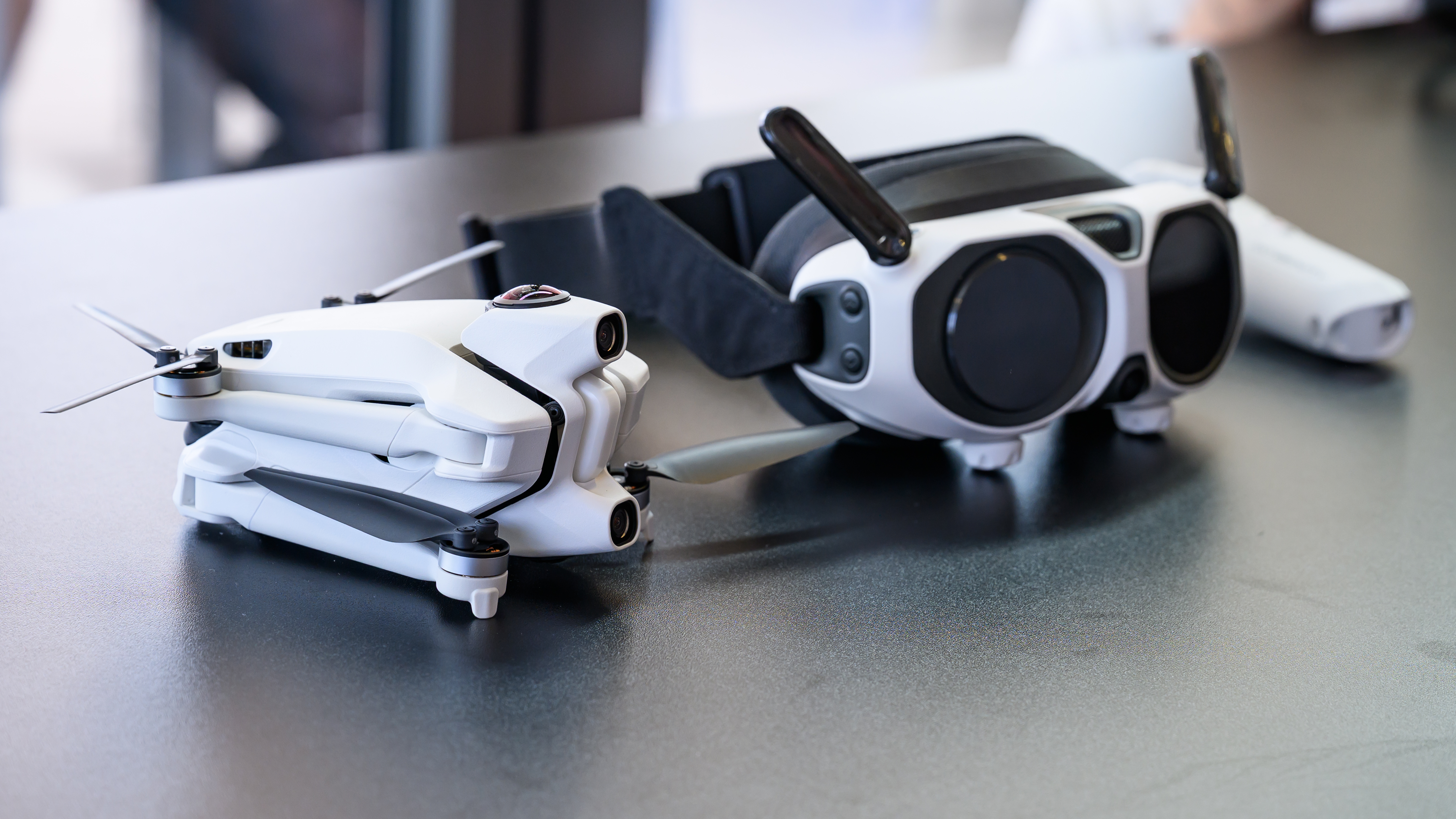 The Antigravity A1 and its accessories on a black surface.