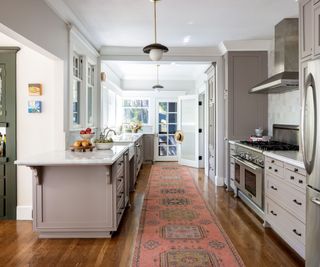 kitchen with greige cabinets and oriental rug