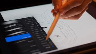 Person drawing on an iPad using an Apple Pencil