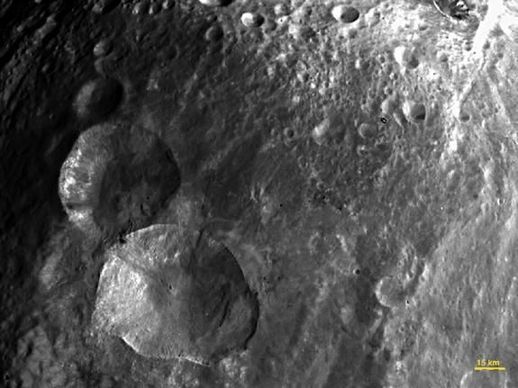 Vesta has snowman craters