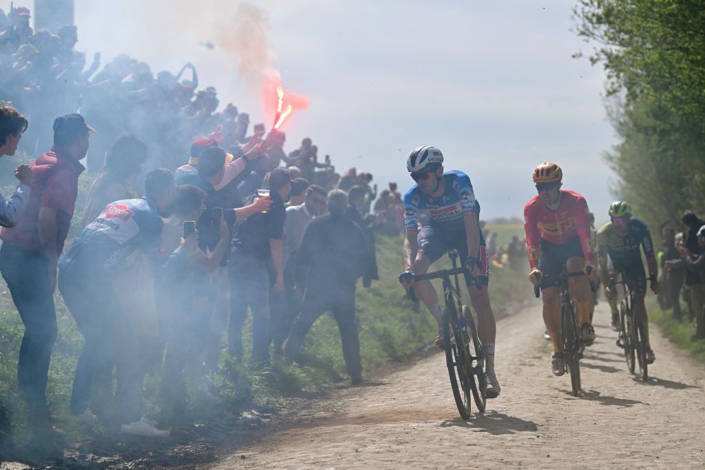 ROUBAIX FRANCE APRIL 07 LR Kasper Asgreen of Denmark and Team Soudal QuickStep and Rasmus Tiller of Norway and Team UnoX Mobility compete in the breakaway passing through the Viesly Quivy cobblestones sector during the 121st ParisRoubaix 2024 a 2597km one day race from Compiegne to Roubaix UCIWT on April 07 2024 in Roubaix France Photo by Luc ClaessenGetty Images