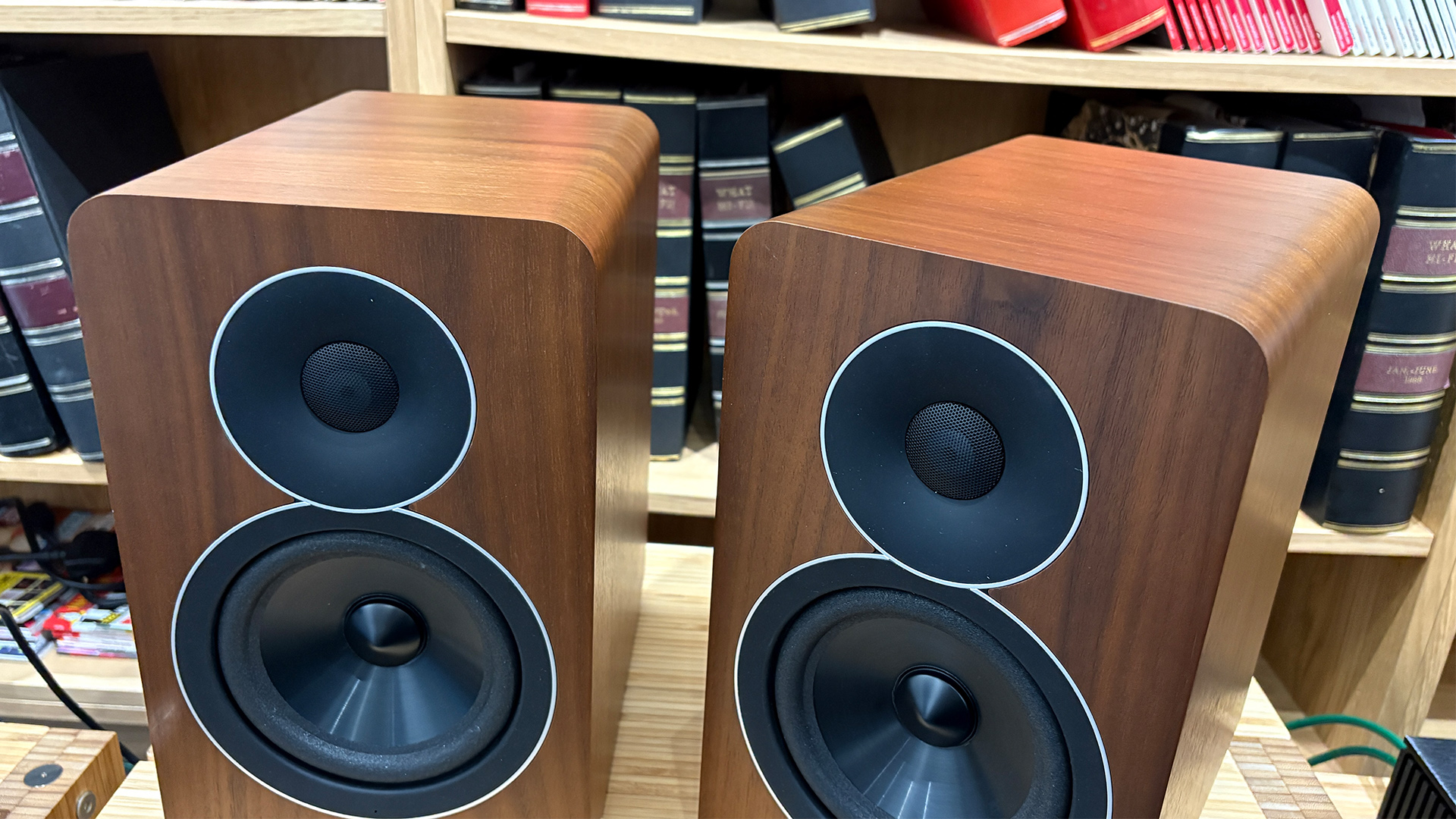 Acoustic Energy AE Active active speakers on hi-fi rack in front of bookcase