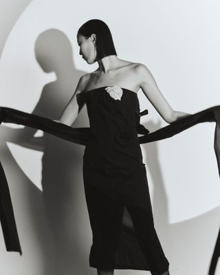 Woman in black Chanel dress