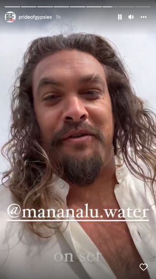 Jason Momoa walking in a white shirt, on the set of Fast X.