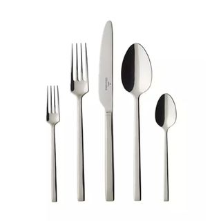 A set of silverware. A small fork, a large fork, and knife, a large spoon, and a teaspoon. white background.