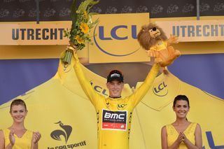 Rohan Dennis in yellow on the stage 1 podium.