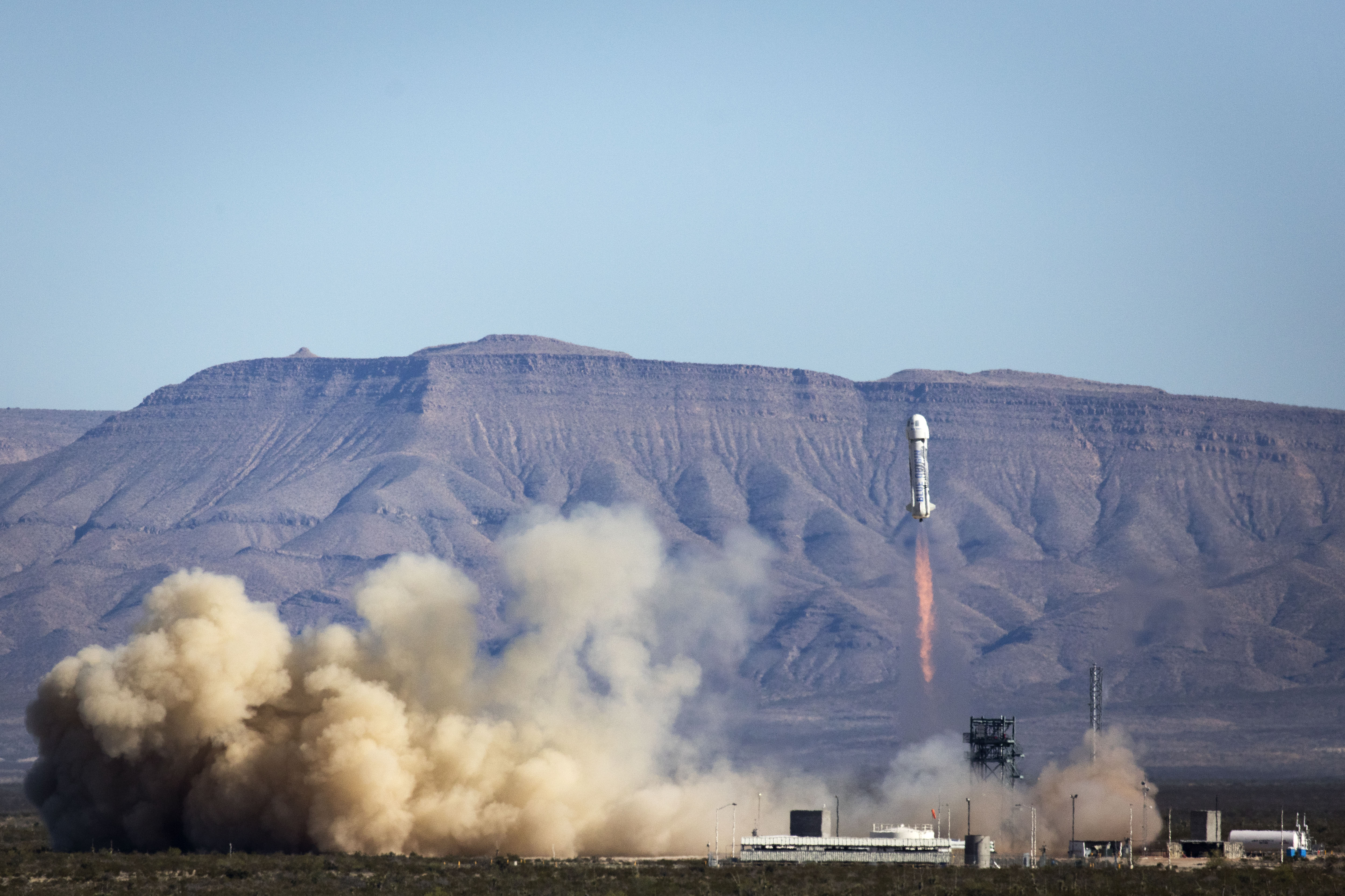 A New Shepard suborbital vehicle, built by the commercial spaceflight company Blue Origin, ascends skyward. The company will attempt to launch and land the same vehicle for a fourth consecutive time this Sunday (June 19). 