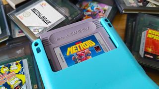 Closeup of Modretro Chromatic cartridge slot with Metroid Prime 2 inserted and carts surrounding handheld