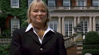 Louise Fletcher in Great Expectations, standing in front of a big house