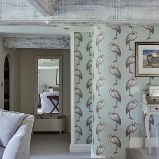dressing room with bird wallpaper and mirror