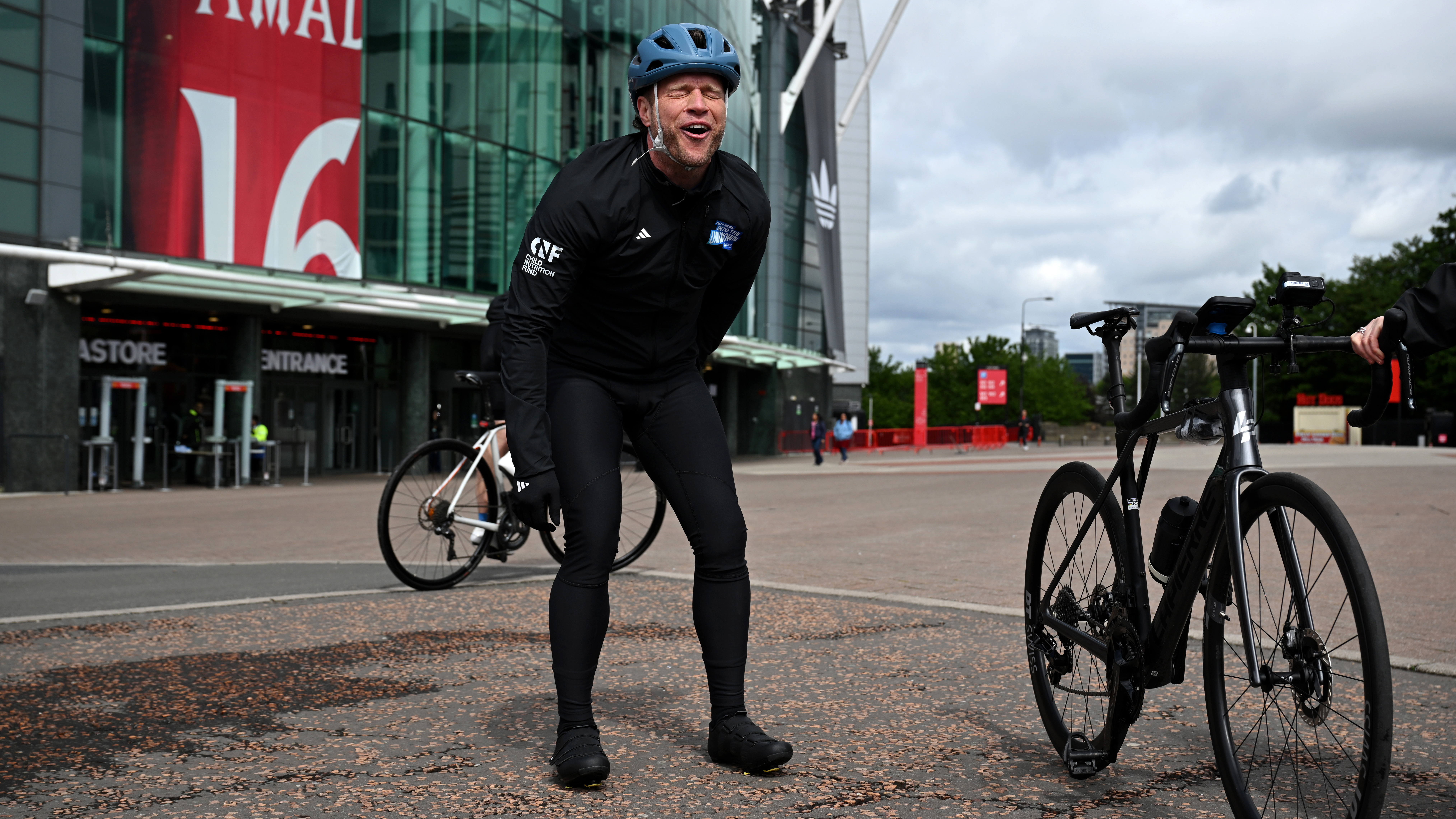 Olly Murs falls off bicycle at the start line for 'Olly Murs: Into The Unknown' at Old Trafford 
