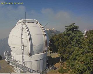 A Thursday (Aug. 20) morning webcam image from Lick Observatory shows the Automated Planet Finder telescope dome as wildfires continue burning on.