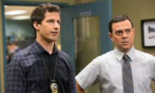 andy samberg as jake peralta and Joe Lo Truglio as chalres boyle in a police station in the show Brooklyn Nine-Nine