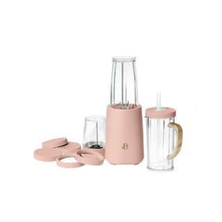 A personal blender set with accessories in pink