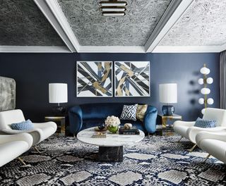 a glamorous living room with a navy blue sofa