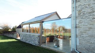 glass link extension between two stone buildings
