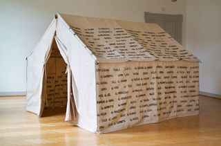 white canvas tent with writing on the sides