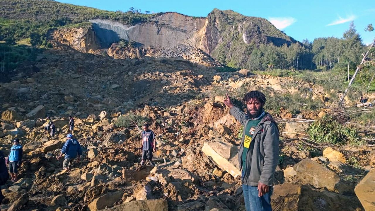 People gather at the site of a landslide in Maip Mulitaka in Papua New Guinea&#039;s Enga Province