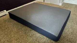 Dreamfoam Essential mattress expanded, on the floor of a bedroom