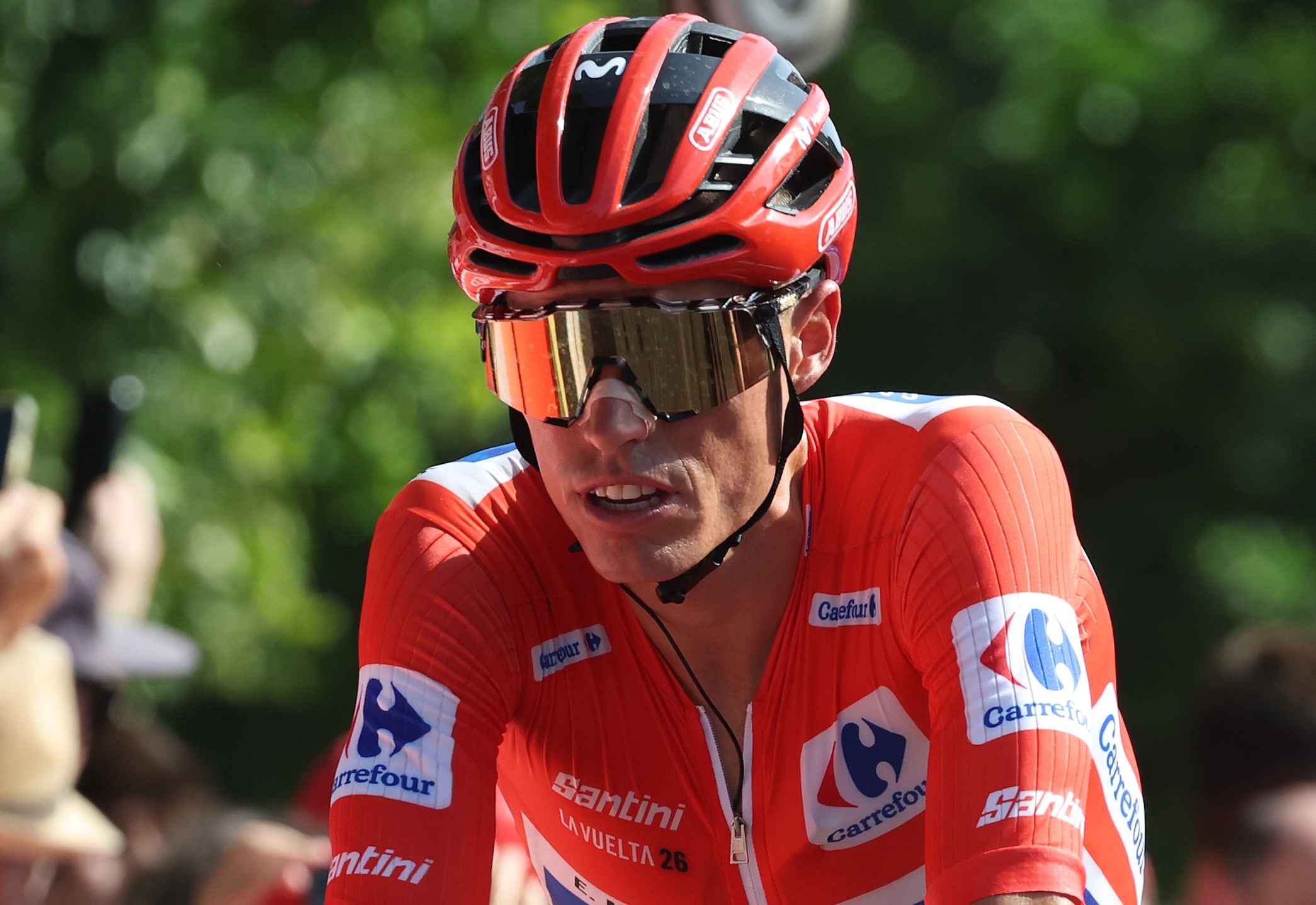 Enric Mas of Movistar Team holds the Red Leader Jersey after stage 15