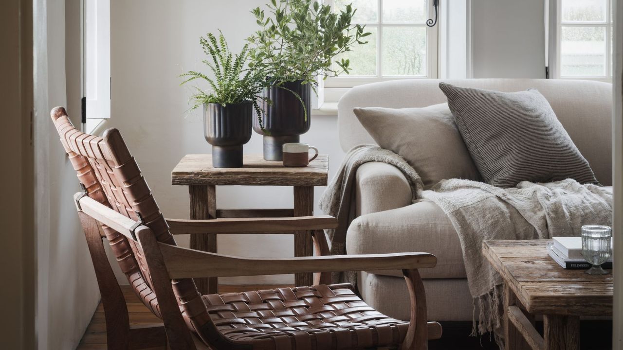 Living room seating with a leather woven chair and a plush cream sofa