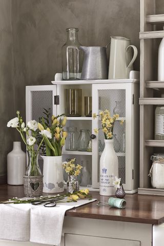 Vases of freshly cut flowers on a worktop.