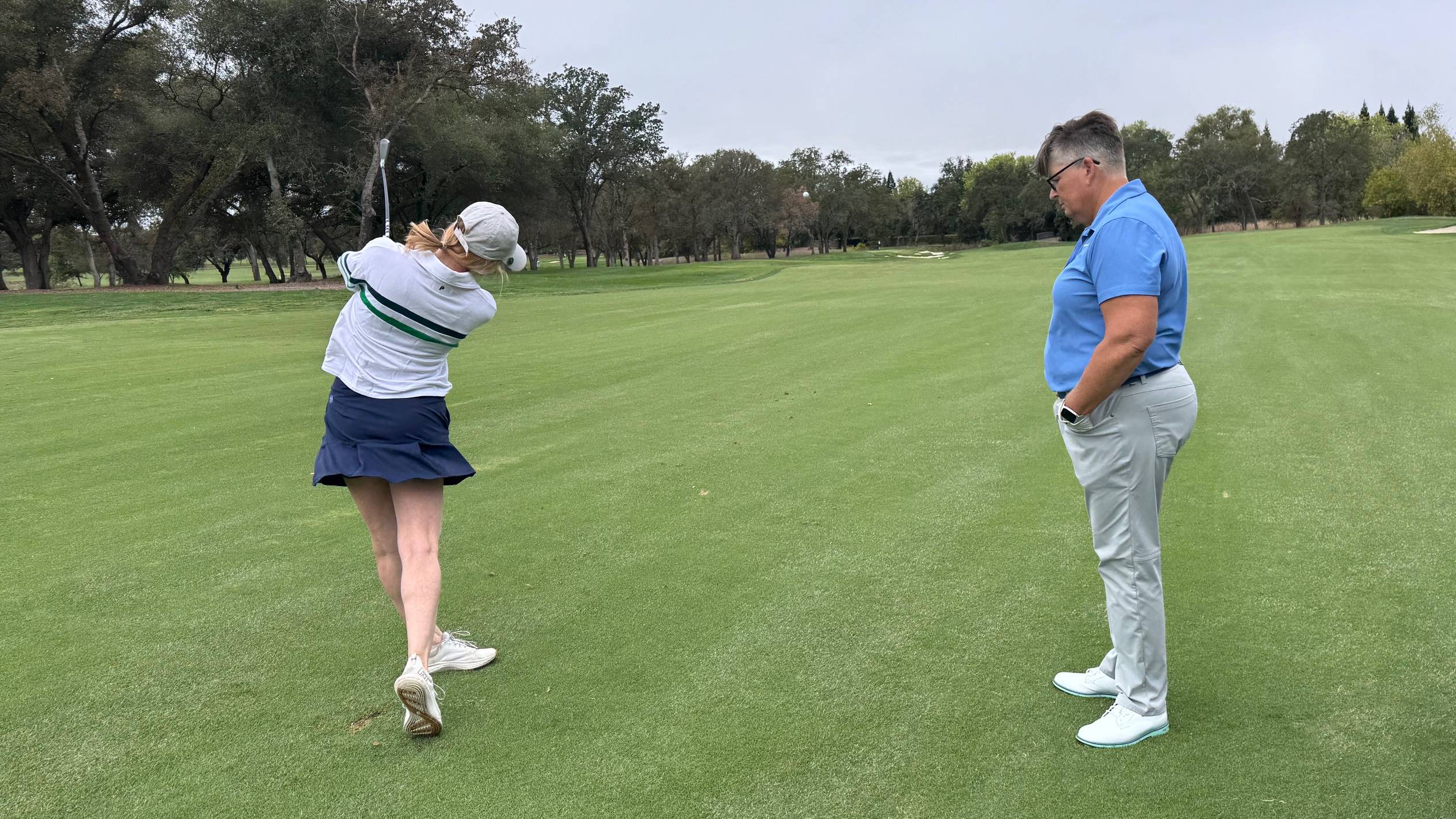 Lauren Katims hitting a 7-iron off the fairway