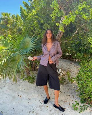 woman wearing long trouser shorts and loafers spring outfit