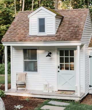 white panelled shed garden room with cute porch