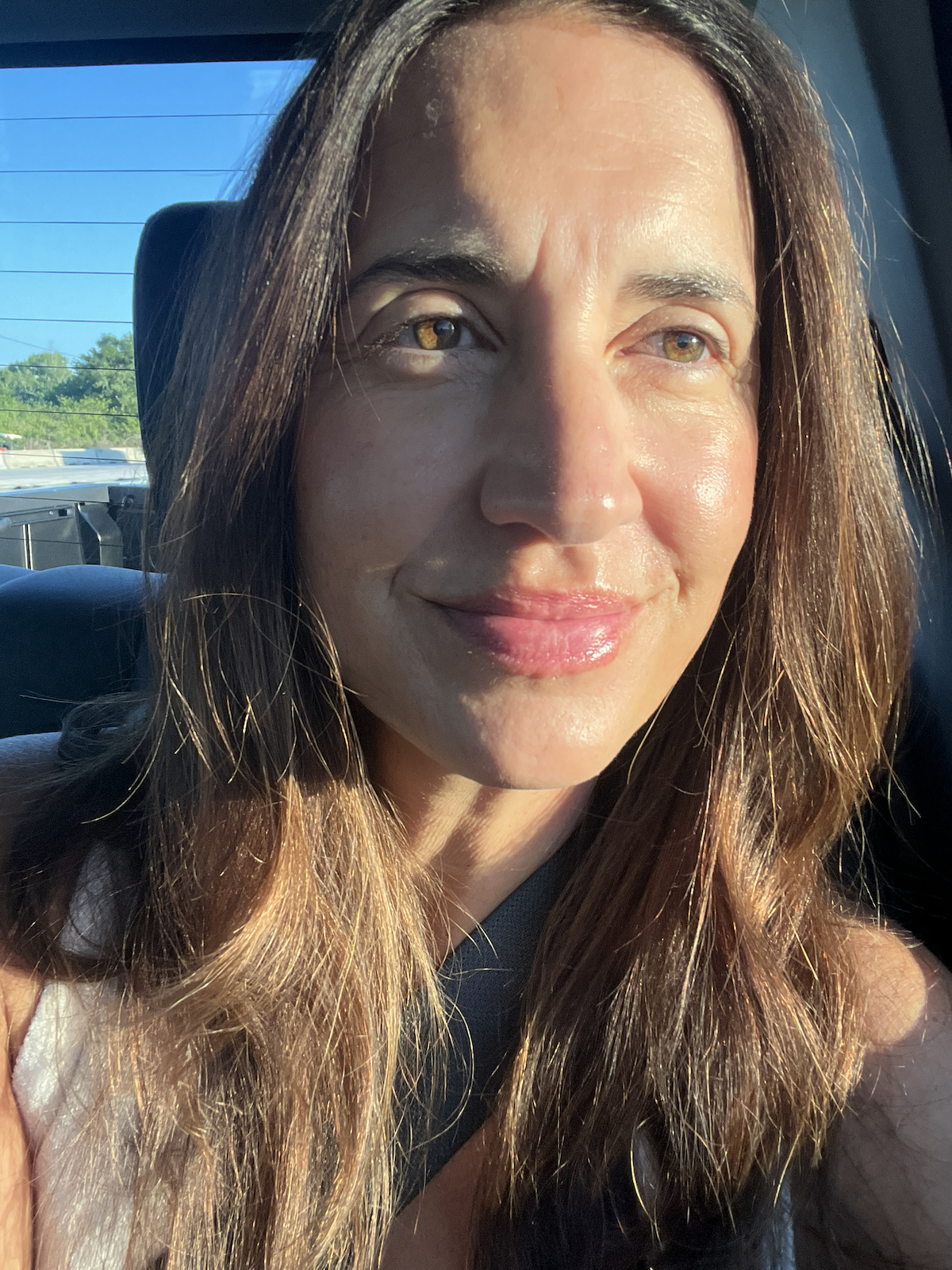 Image of beauty editor Donna sitting in a car with sunlight hitting her face