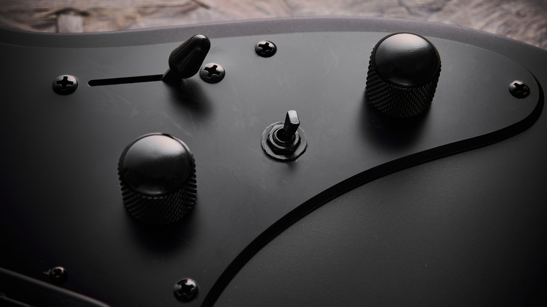 The alter switch, volume, and tone controls on the Ibanez Iron Label AZA41B1 electric guitar