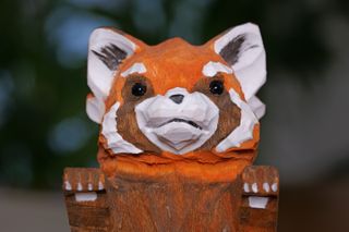 Close up on the face of a red panda figurine